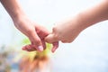 Female childÃ¢â¬â¢s hand holding the hand of elder male shot with bokeh background and horizontal. Concept of fatherÃ¢â¬â¢s day